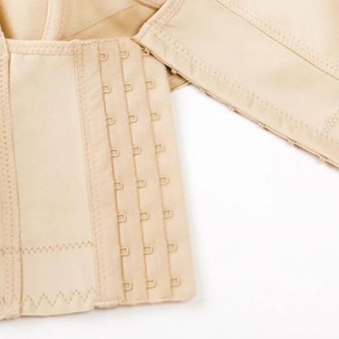 Close-up of the hook and eye closure of a beige push-up shaping bra, showcasing its seamless design and adjustable fit.
